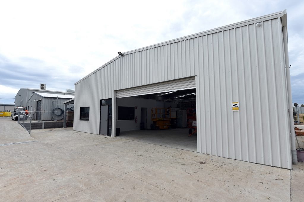 White warehouse building constructed from a structural steel frame cladded in metal sheeting